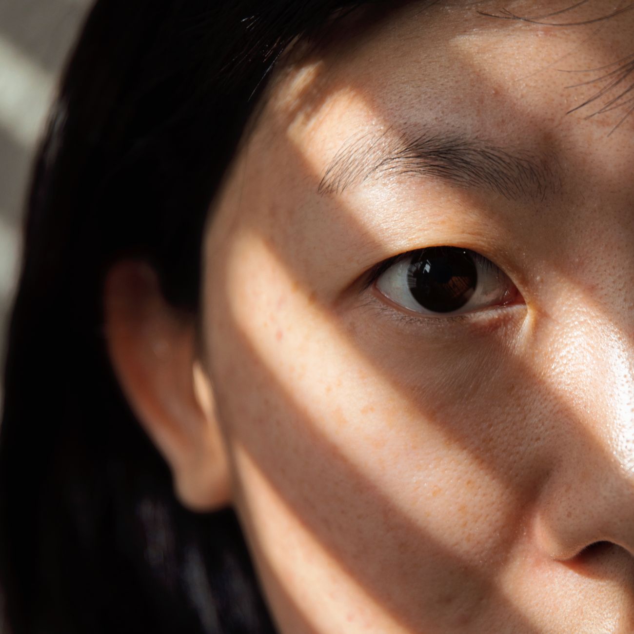 portrait of woman in her thirties with clear glowing skin in natural light