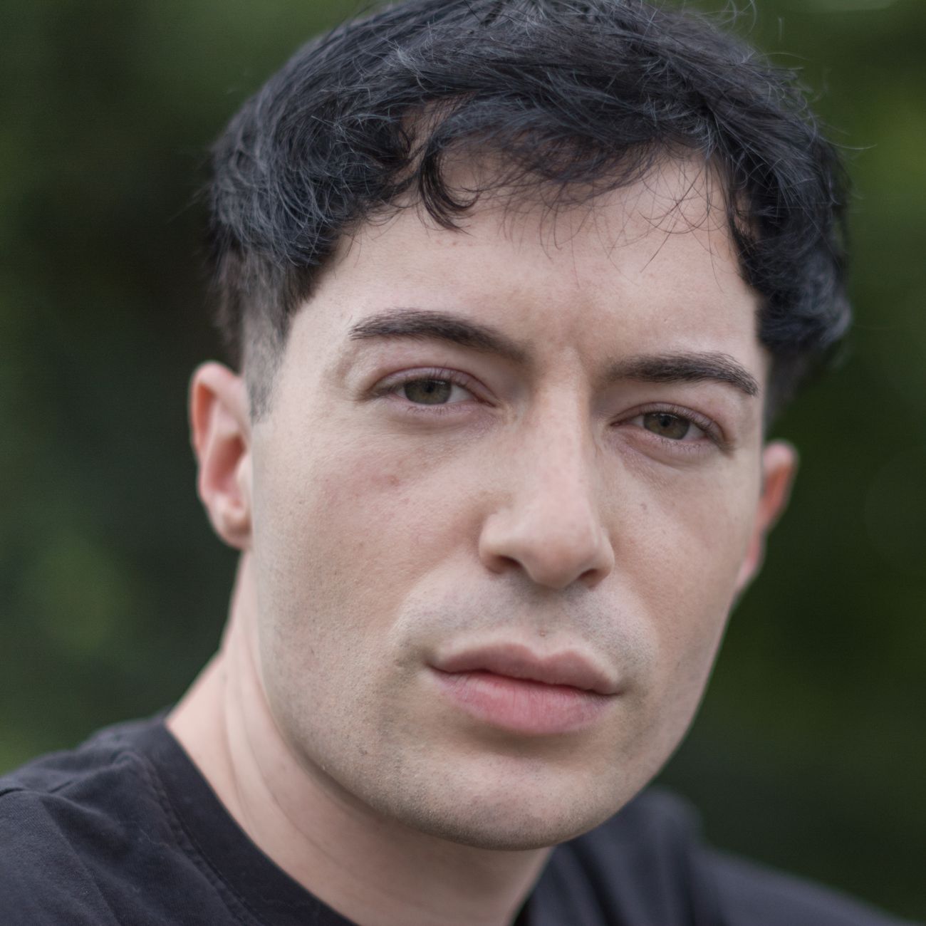 portrait of man in his forties with calm clear complexion in a bright neutral setting