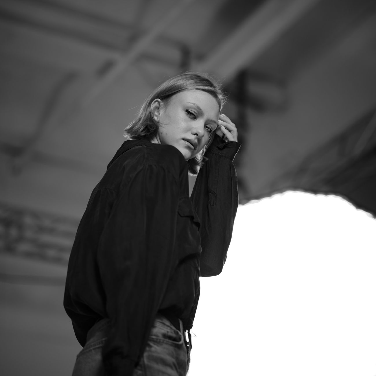 portrait of woman with a calm expression in a spare, well-lit apartment